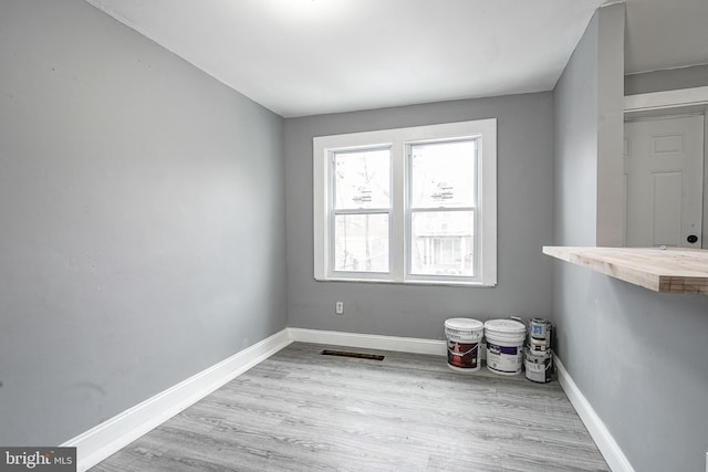 empty room with light hardwood / wood-style flooring