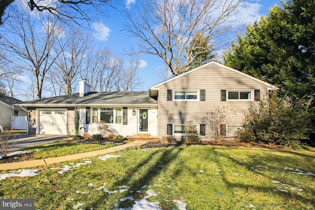 split level home with a garage and a front yard