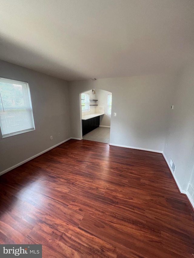 unfurnished room featuring dark wood-type flooring