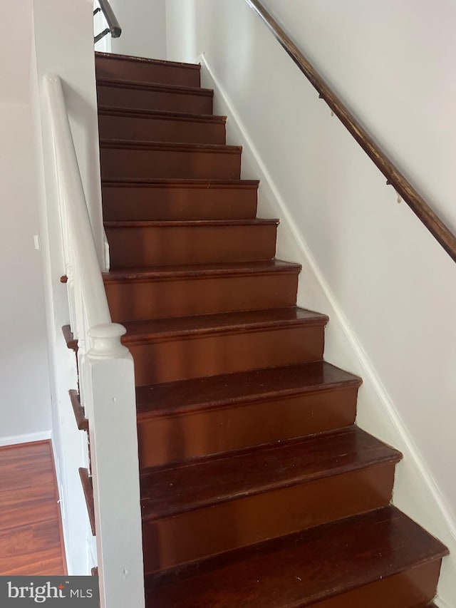 stairs with hardwood / wood-style flooring