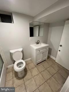 bathroom with vanity, tile patterned flooring, and toilet