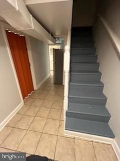 stairs featuring tile patterned flooring