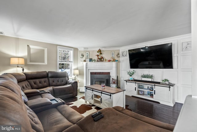 living room featuring dark hardwood / wood-style flooring and ornamental molding