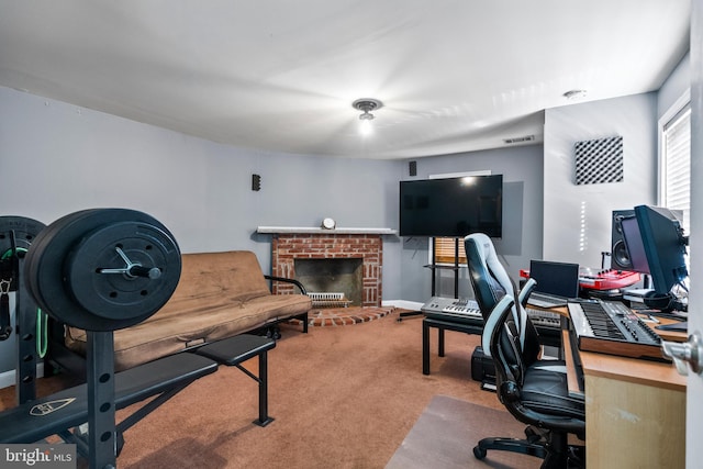 office space featuring a fireplace and carpet floors