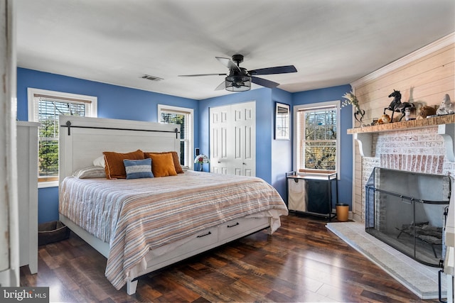 bedroom with multiple windows, dark wood-type flooring, and ceiling fan