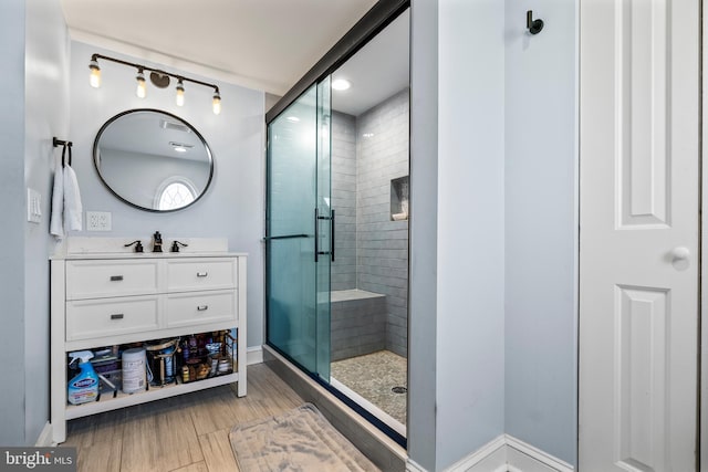 bathroom with vanity, hardwood / wood-style floors, and walk in shower