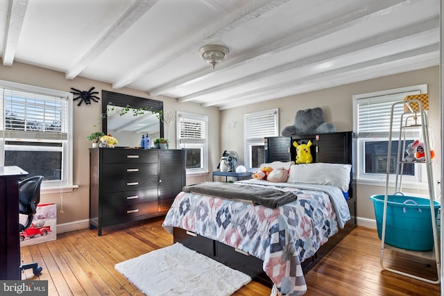 bedroom featuring beamed ceiling and hardwood / wood-style floors