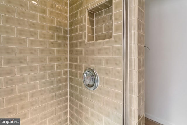 bathroom with tiled shower