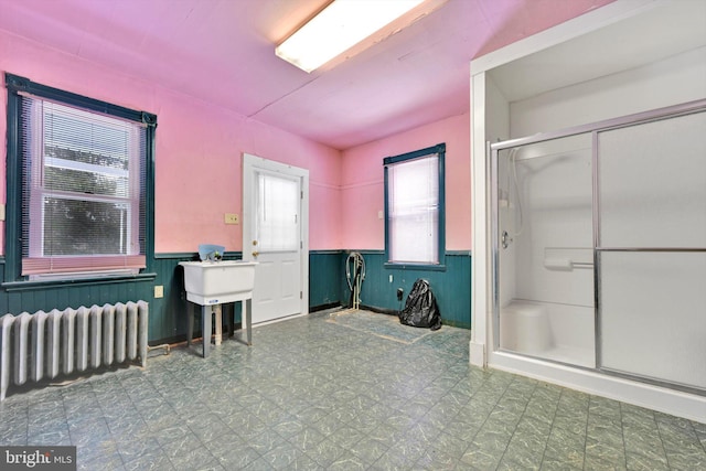 bathroom with radiator and a shower