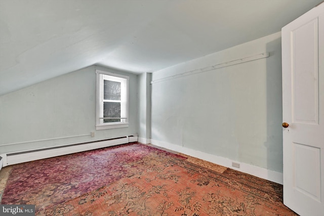 bonus room with vaulted ceiling, a baseboard heating unit, and dark carpet