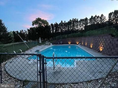 view of pool at dusk