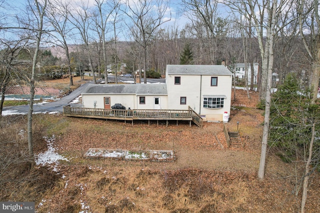 rear view of house featuring a deck