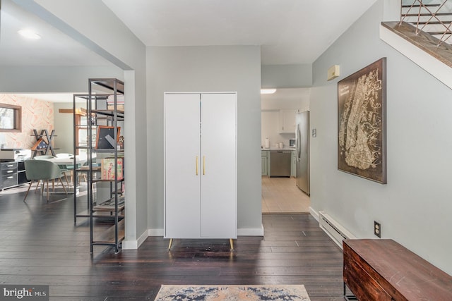 foyer entrance with dark hardwood / wood-style flooring and a baseboard radiator