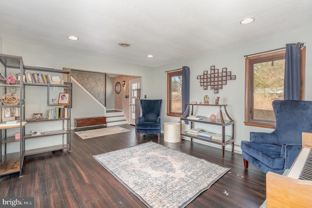 living area with plenty of natural light and dark hardwood / wood-style floors