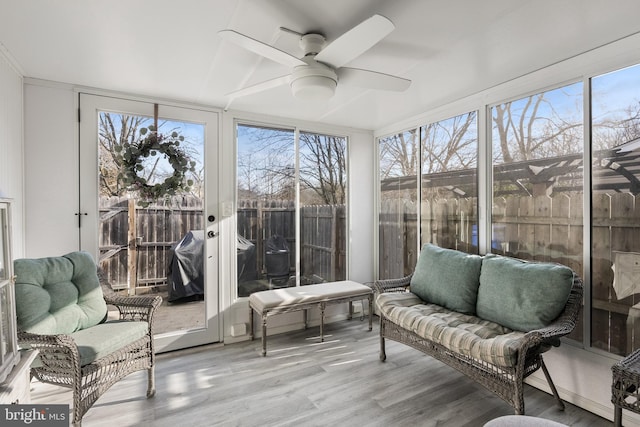 sunroom / solarium featuring ceiling fan and plenty of natural light