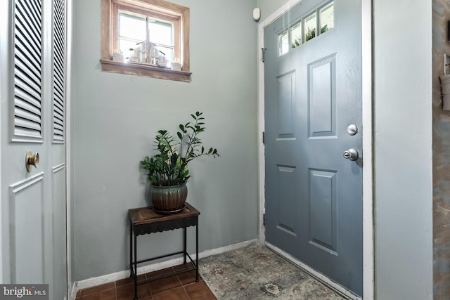 entryway featuring dark tile patterned flooring