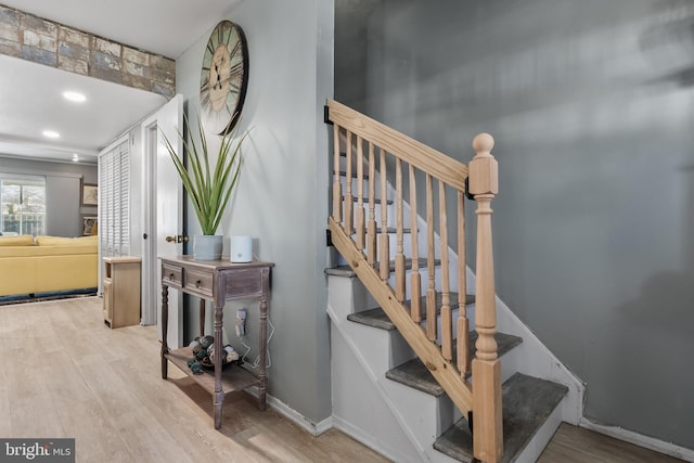 stairway with hardwood / wood-style flooring