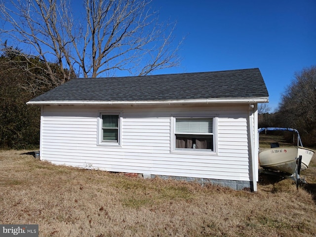 view of side of home with a lawn