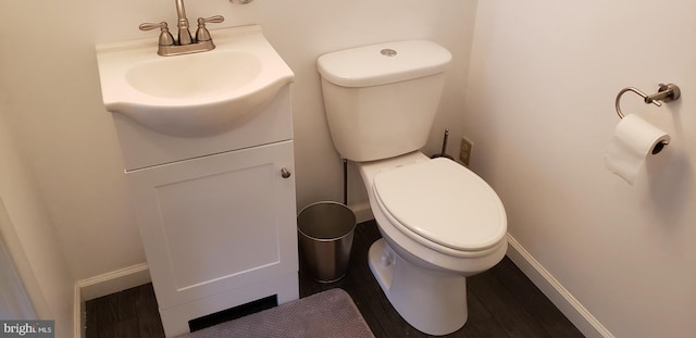 bathroom with vanity, toilet, and wood-type flooring