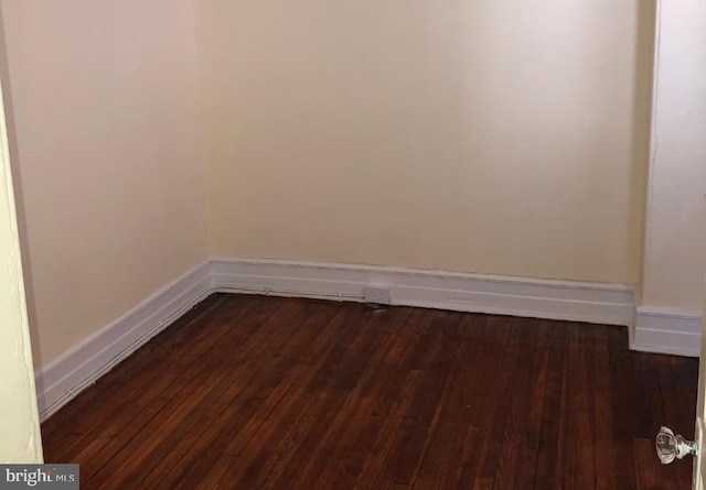 empty room featuring dark wood-type flooring