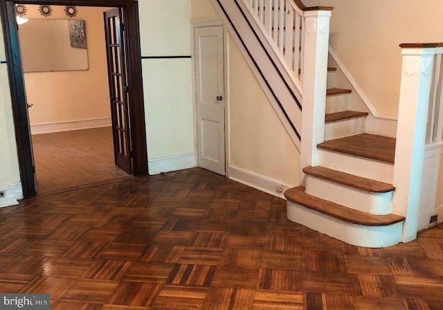 stairs featuring parquet floors