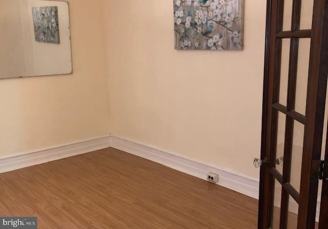 unfurnished room with hardwood / wood-style floors