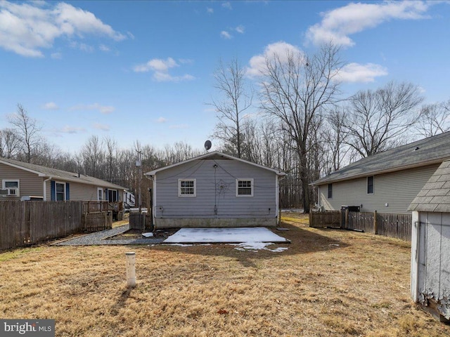 rear view of house with a yard and cooling unit