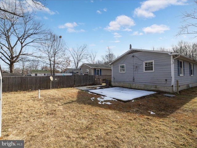 rear view of house featuring a patio and a lawn