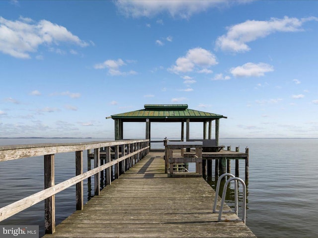 view of dock featuring a gazebo and a water view