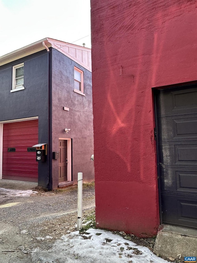 view of snow covered exterior with a garage