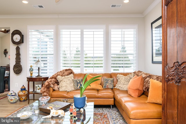 living room with ornamental molding and wood-type flooring