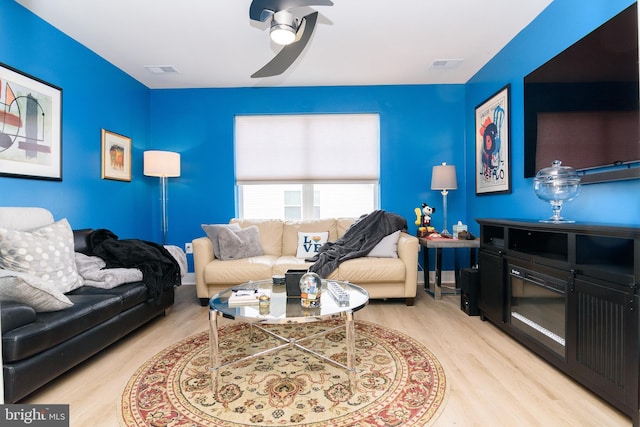 living room featuring ceiling fan and light wood-type flooring