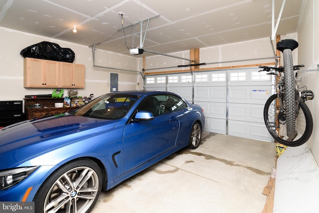 garage featuring a garage door opener and electric panel