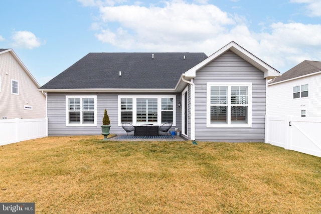 back of house featuring a patio area and a lawn