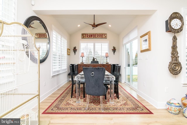 dining space with ceiling fan, vaulted ceiling, and hardwood / wood-style floors