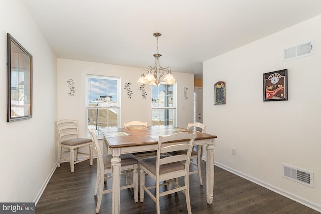 dining area featuring a chandelier and dark hardwood / wood-style flooring