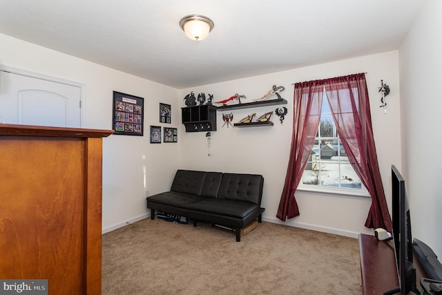 sitting room featuring light colored carpet