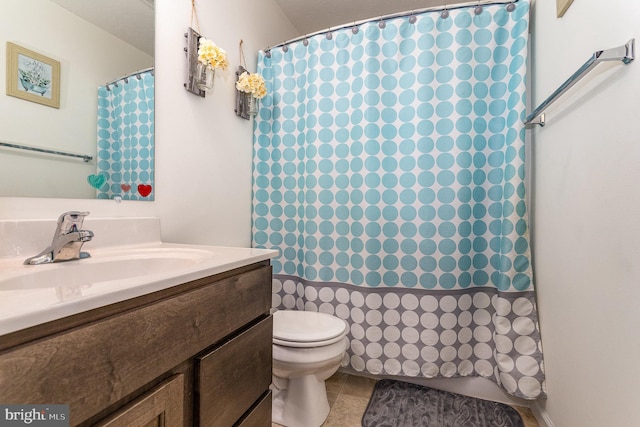 bathroom featuring tile patterned flooring, vanity, and toilet