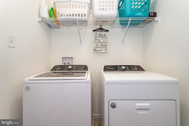 clothes washing area with washer and clothes dryer