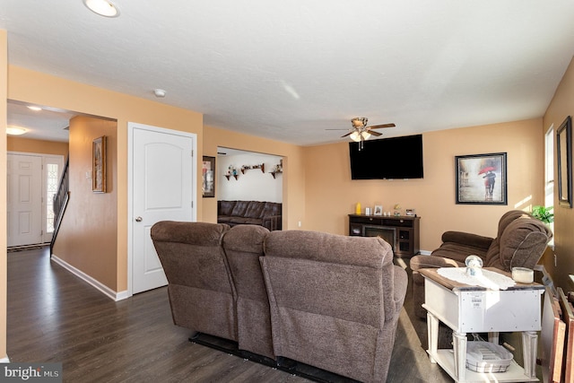 living room with dark hardwood / wood-style floors and ceiling fan