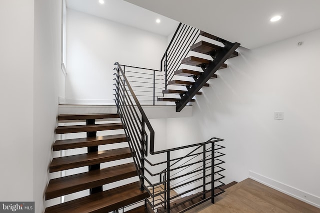 staircase featuring hardwood / wood-style floors