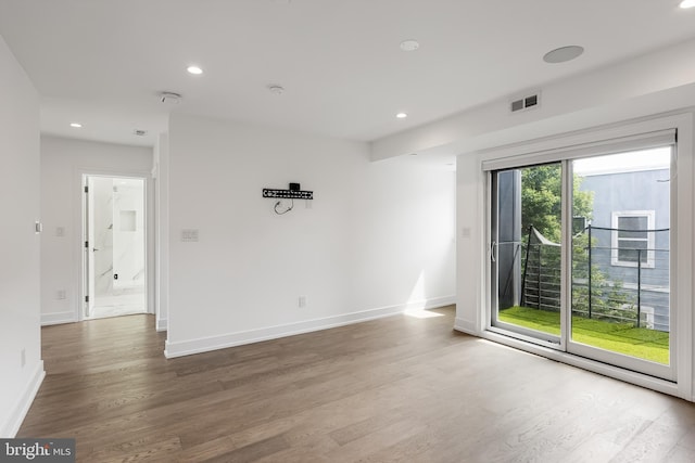 spare room with hardwood / wood-style floors