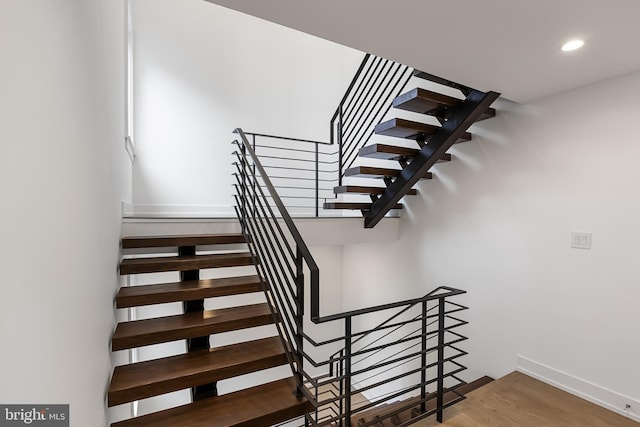 stairway featuring hardwood / wood-style floors