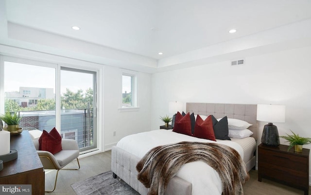 bedroom with access to outside and light wood-type flooring