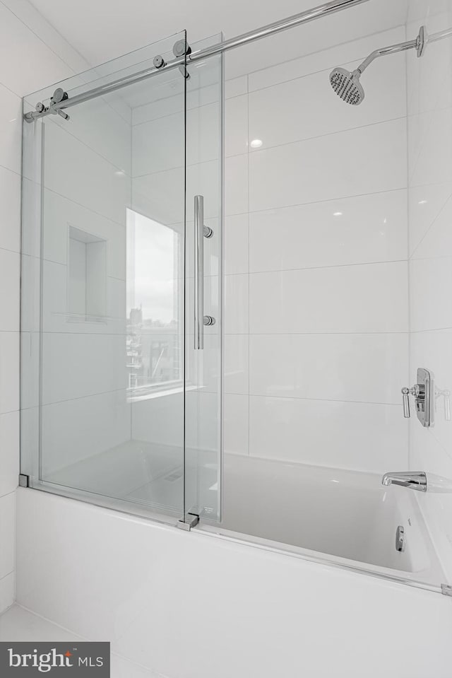 bathroom with shower / bath combination with glass door