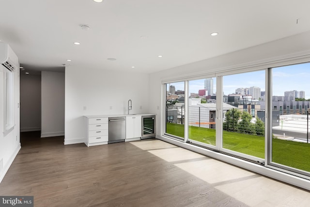 bar with white cabinetry, wood-type flooring, beverage cooler, and dishwasher