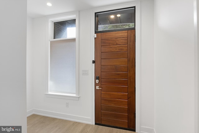 foyer entrance with light wood-type flooring