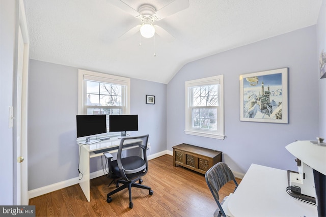 home office with lofted ceiling, ceiling fan, wood finished floors, and baseboards