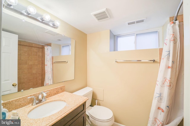 full bath with visible vents, vanity, and toilet