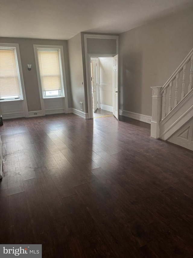 unfurnished living room featuring dark hardwood / wood-style floors